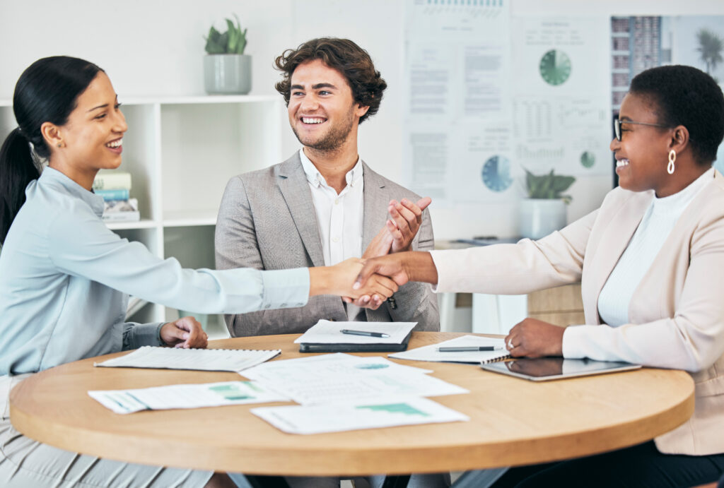 A handshake between professionals illustrates successful customer acquisition.