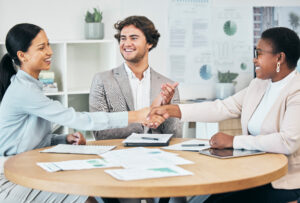 A handshake between professionals illustrates successful customer acquisition.