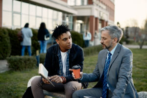 Young professional receiving guidance, showing the value of finding a mentor for growth.